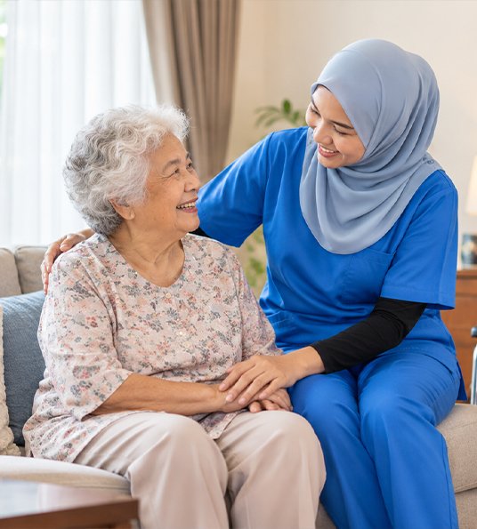 Caregiver talking with an elderly resident